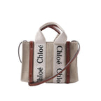 Chloé Woody Mini handbag in beige canvas with brown leather trim, logo webbing top handles and a slim detachable shoulder strap.