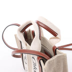 Bolso de mano de lona y piel Chloé Woody Nano de 2 vías en beige y marrón