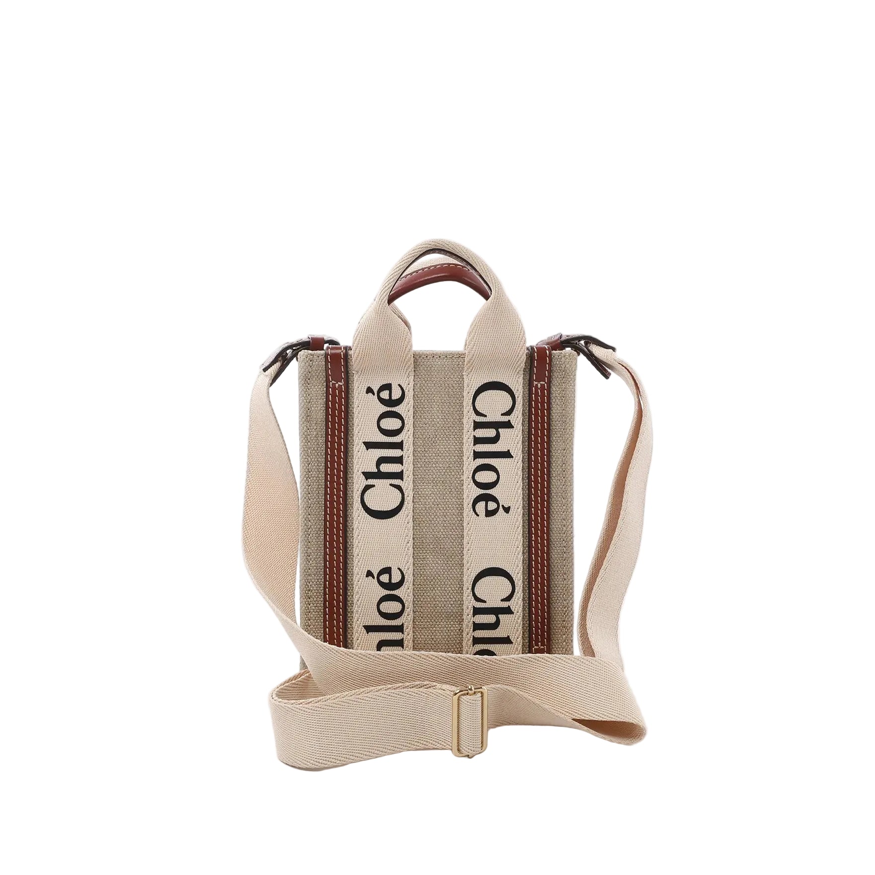 Front view of Chloé Woody North South mini tote in beige canvas with vertical “Chloé” logo webbing, brown leather trim, top handles, and an adjustable beige shoulder strap.
