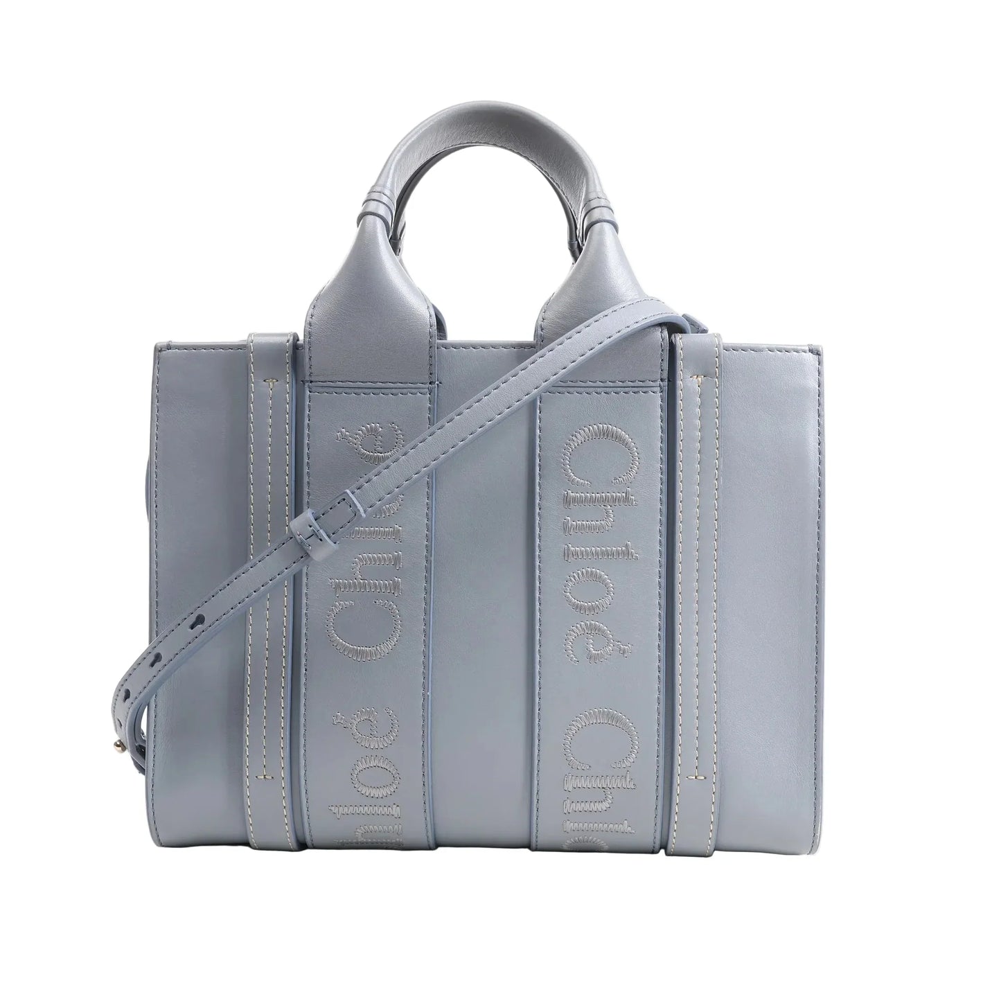 Chloé Woody Small 2Way Handbag in blue leather featuring logo-embroidered vertical straps, top handles, adjustable shoulder strap, and structured rectangular silhouette, displayed on a white background.