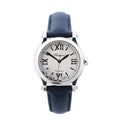 Chopard Happy Sport watch with silver dial, Roman numeral markers, floating diamond accents, stainless steel case and blue leather strap.