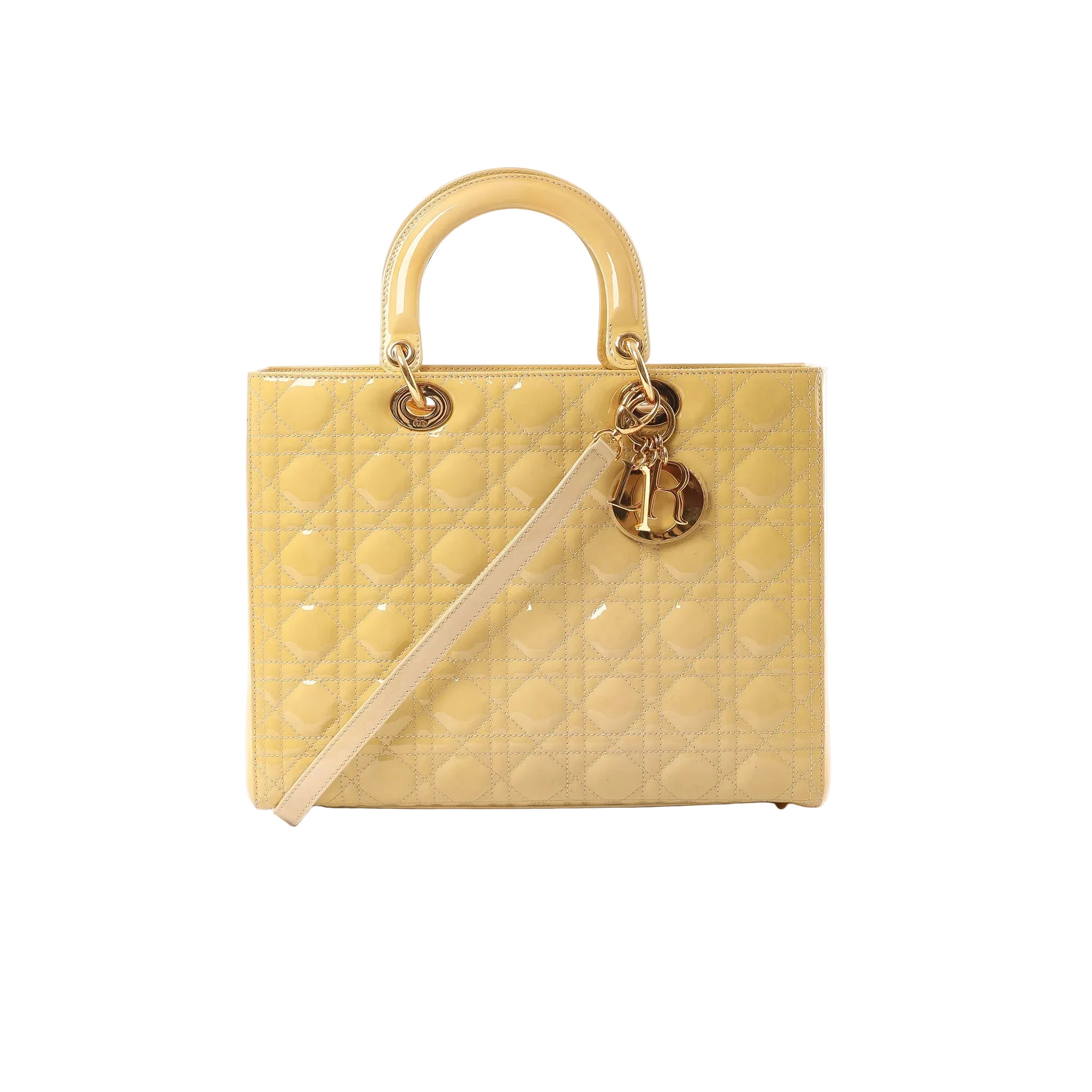 Yellow Dior Lady Dior Large Cannage quilted leather handbag with top handles, gold-tone letter charms and detachable shoulder strap on white background.
