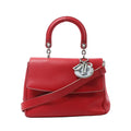 Dior Be Dior Small handbag in red leather with a rounded top handle, detachable shoulder strap, structured flap and silver-tone Dior charms.