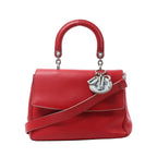 Dior Be Dior Small handbag in red leather with a rounded top handle, detachable shoulder strap, structured flap and silver-tone Dior charms.