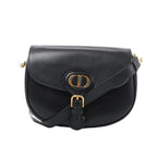 Front view of a black Christian Dior Bobby leather crossbody bag with a rounded flap, gold-tone CD initials, buckle detail and leather strap.