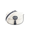 White Dior Bobby Small crossbody bag with perforated Oblique pattern, navy CD front buckle, navy trim, and wide white-and-navy shoulder strap.