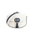 White Dior Bobby Small crossbody bag with perforated Oblique pattern, navy CD front buckle, navy trim, and wide white-and-navy shoulder strap.