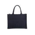Front view of Christian Dior Book Tote in navy blue canvas with a tonal Cannage pattern, Christian Dior Paris lettering and twin handles.