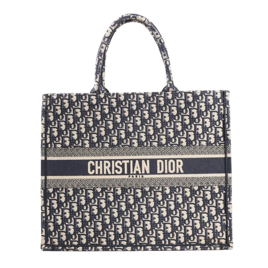 Dior Book Tote large shoulder bag in navy blue Oblique canvas with all-over “Dior” monogram pattern and bold “Christian Dior Paris” logo embroidered across the front.