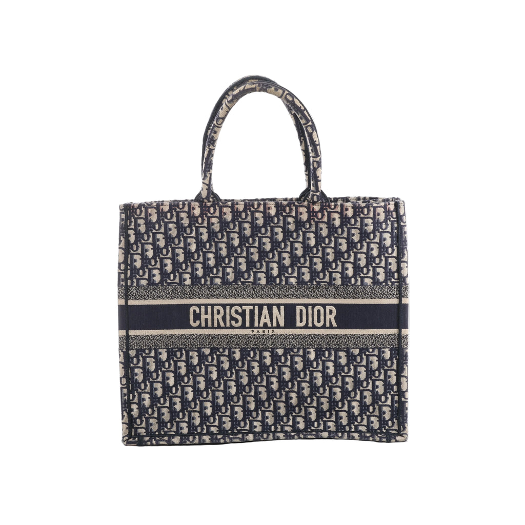 Navy blue and beige Christian Dior Book Tote Large with an all-over Oblique pattern, twin handles and a Christian Dior Paris signature band across the front.
