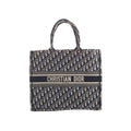 Navy blue and beige Christian Dior Book Tote Large with an all-over Oblique pattern, twin handles and a Christian Dior Paris signature band across the front.