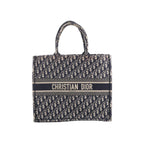 Navy blue and beige Christian Dior Book Tote Large with an all-over Oblique pattern, twin handles and a Christian Dior Paris signature band across the front.