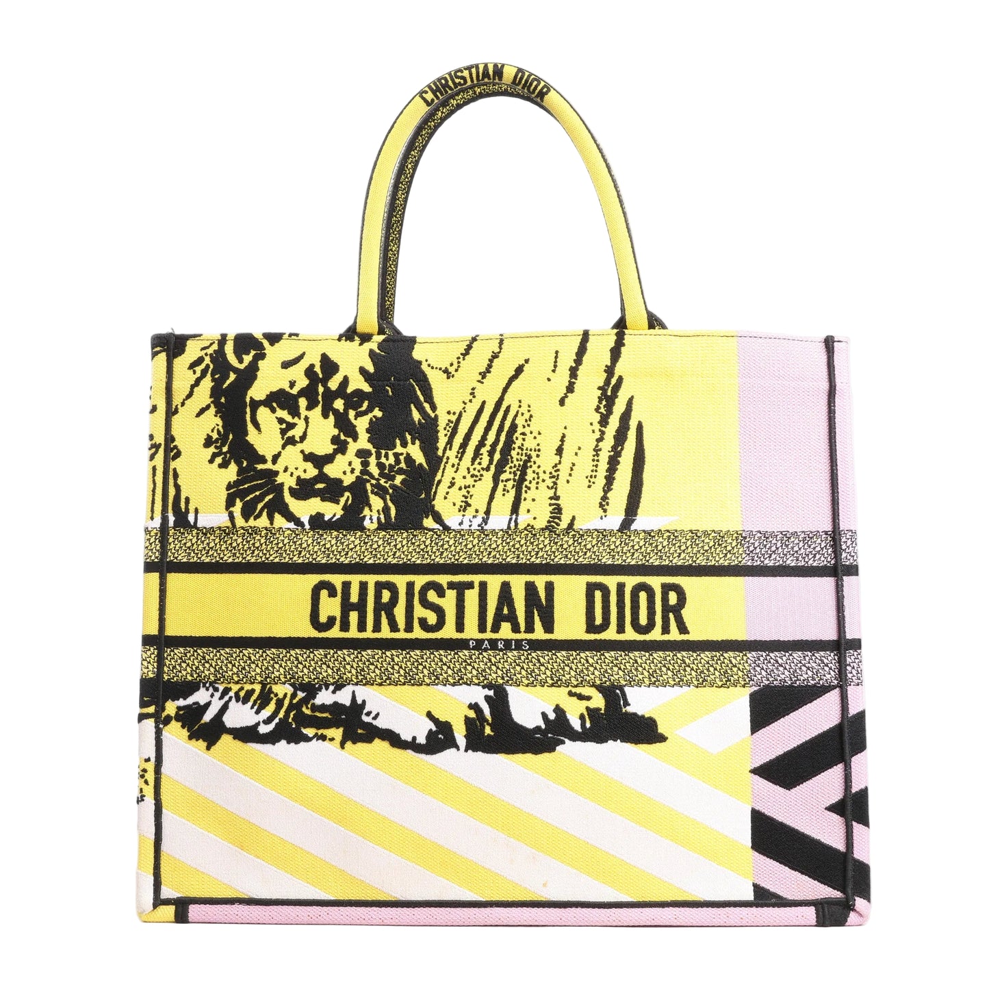 Christian Dior Book Tote Large shoulder bag in yellow and purple canvas featuring bold black lion motif, signature "CHRISTIAN DIOR PARIS" embroidery, and dual top handles.