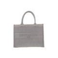 Front view of Christian Dior Book Tote Medium in gray canvas with a tonal Cannage pattern, Christian Dior Paris lettering and matching twin handles.