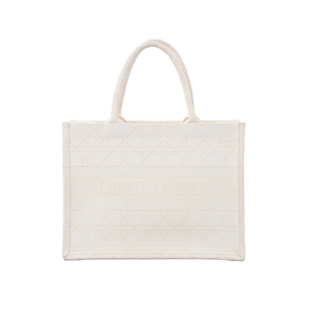 Front view of Christian Dior Book Tote Medium in white canvas with tonal Cannage embroidery, Christian Dior Paris lettering and twin rounded handles.