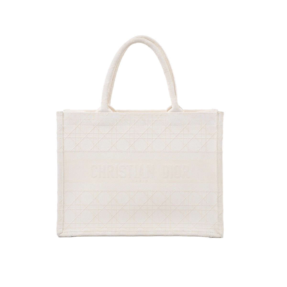 Front view of Christian Dior Book Tote Medium in white canvas with tonal Cannage embroidery, Christian Dior Paris lettering and twin rounded handles.