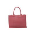 Front view of Christian Dior Book Tote Medium in pink leather with tonal embossed Christian Dior Paris lettering and matching rounded twin handles.