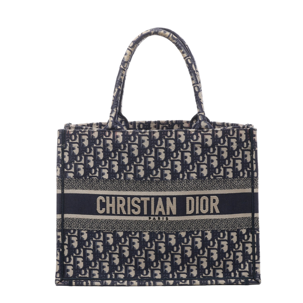 Navy and beige Christian Dior Book Tote Medium with Oblique monogram canvas, twin top handles and CHRISTIAN DIOR PARIS logo band.