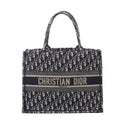Navy and beige Christian Dior Book Tote Medium with Oblique monogram canvas, twin top handles and CHRISTIAN DIOR PARIS logo band.