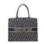 Navy and beige Christian Dior Book Tote Medium with Oblique monogram canvas, twin top handles and CHRISTIAN DIOR PARIS logo band.
