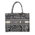 Navy blue Christian Dior Book Tote Medium with Toile de Jouy embroidered wildlife motifs, dual top handles and CHRISTIAN DIOR PARIS logo band.