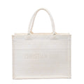 White Christian Dior Book Tote Medium canvas bag with tonal geometric embroidery, dual top handles and CHRISTIAN DIOR lettering across the front.
