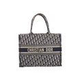 Navy blue and beige Christian Dior Book Tote with an all-over Oblique pattern, twin handles and a Christian Dior Paris signature band across the front.