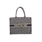 Navy blue and beige Christian Dior Book Tote with an all-over Oblique pattern, twin handles and a Christian Dior Paris signature band across the front.
