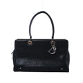 Black Christian Dior East-West Lady Dior leather bag with Cannage quilting, long top handles and silver-tone DIOR letter charms.
