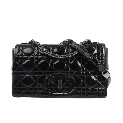 Dior Caro black patent leather crossbody bag featuring signature Cannage quilted stitching, antique silver-tone CD logo clasp, and adjustable chain strap.