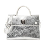 Front view of Christian Dior Diorever Medium Leather 2Way Handbag in metallic silver, featuring a structured design, top handle, detachable shoulder strap, and signature Dior clasp closure against a white background.
