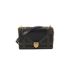 Black Dior Diorama leather shoulder bag with gold-tone studded trim, chunky chain strap, leather shoulder strap, and front clasp closure.