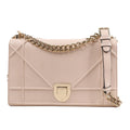 Dior Diorama Shoulder Bag in powder beige calfskin leather with signature geometric stitching, gold-tone crest clasp, and chunky chain strap, displayed against a white background.