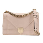 Dior Diorama Shoulder Bag in powder beige calfskin leather with signature geometric stitching, gold-tone crest clasp, and chunky chain strap, displayed against a white background.