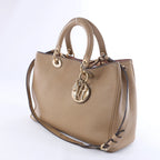 Bolso de mano mediano de dos vías de piel Cannage de Christian Dior en color camello