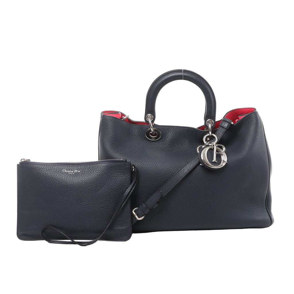 Navy blue Christian Dior Diorissimo grained leather handbag with top handles, shoulder strap, silver-tone Dior charms, red interior and matching zip pouch.