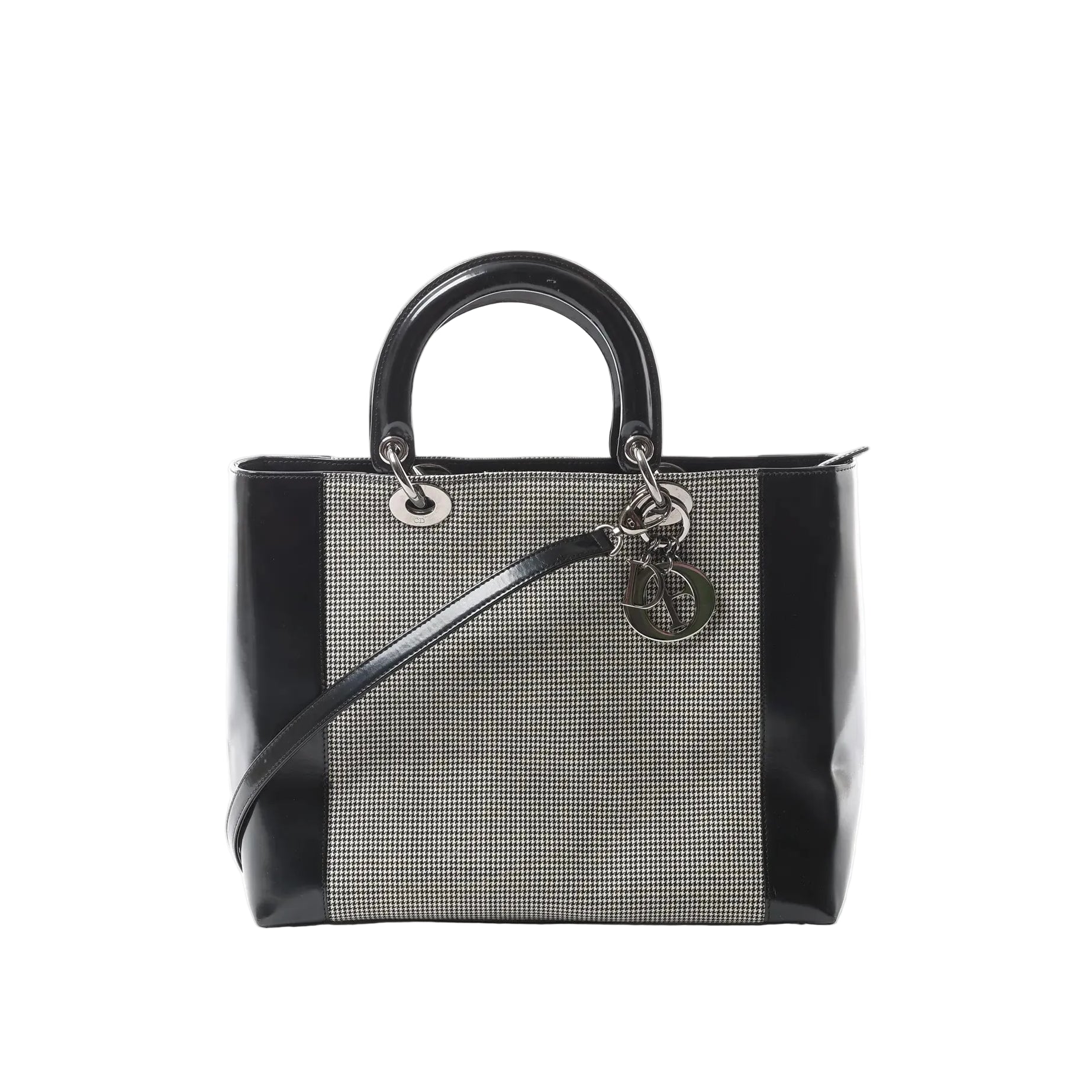 Dior Lady Dior handbag with black patent leather sides and handles, black-and-white canvas panel, silver-tone hardware, and hanging Dior letter charms.