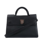 Front view of a black Dior Diorever grained leather handbag with a rounded top handle, silver-tone shield clasp and shoulder strap.