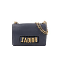 Dior J’Adior navy grained leather crossbody bag with gold-tone chain strap and large gold “J’ADIOR” logo on the front flap.