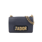 Dior J’Adior navy grained leather crossbody bag with gold-tone chain strap and large gold “J’ADIOR” logo on the front flap.