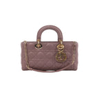 Pink Dior Lady D-Joy quilted leather handbag with rounded top handle, gold-tone DIOR charms and chain-and-leather shoulder strap.