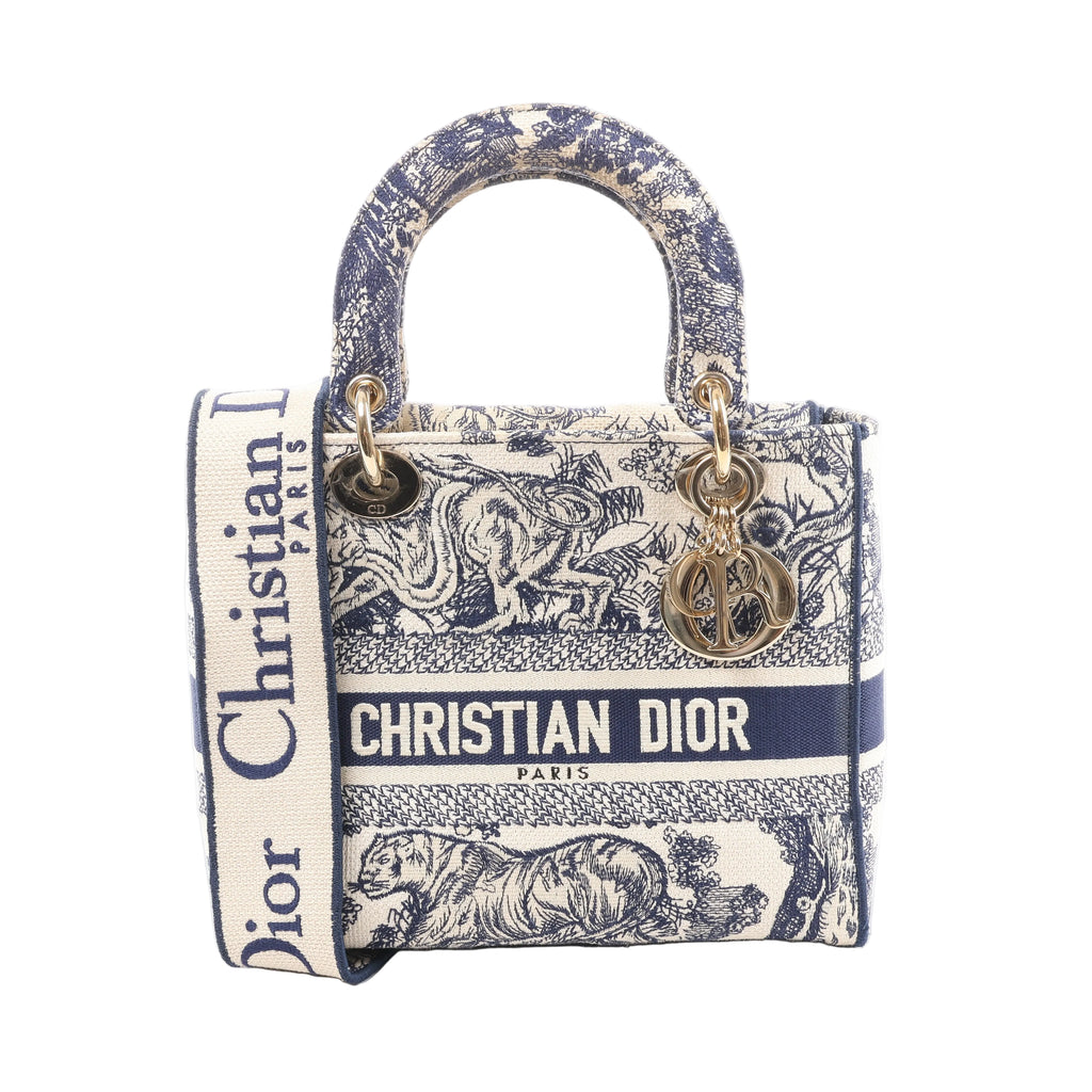Beige and navy Christian Dior Lady D-Lite canvas bag with Toile de Jouy animal print, CHRISTIAN DIOR logo band, top handles, wide strap and gold-tone charms.
