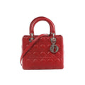 Red Dior Lady Dior Cannage quilted leather handbag with top handles, detachable shoulder strap, and silver-tone DIOR letter charm