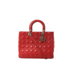 Red Dior Lady Dior large leather bag with Cannage quilting, round top handles, shoulder strap, and hanging Dior letter charms