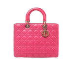 Pink Christian Dior Lady Dior Large leather handbag with Cannage quilting, rounded top handles and dangling gold-tone Dior letter charms.