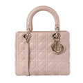 Dior Lady Dior pink Cannage-quilted leather handbag with rounded top handles, gold-tone Dior charms and detachable shoulder strap.