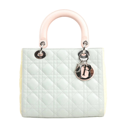 Dior Lady Dior large handbag in pastel blue leather with Cannage quilting, pink top handles, yellow side panels, and silver-tone Dior letter charms.
