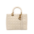 Beige Christian Dior Lady Dior Large leather handbag with Cannage quilting, rounded top handles, a matching shoulder strap and gold-tone Dior charms.