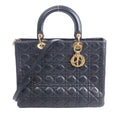 Black Christian Dior Lady Dior Large Cannage leather handbag with top handles, shoulder strap and gold-tone DIOR charms.