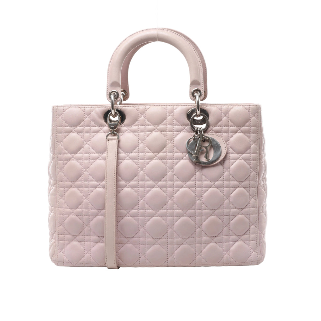 Pale pink Christian Dior Lady Dior Large handbag with Cannage quilting, rounded top handles, a matching shoulder strap and silver-tone Dior charms.